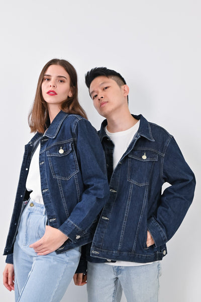 A Couple in Denim Jeans and Jacket Holding Their Hands  Free Stock Photo